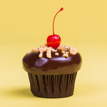 Load image into Gallery viewer, banana split cupcake with banana cake, marshmallow filling, and strawberry frosting, that has been dipped in ganache and finished with crushed peanuts and a maraschino cherry