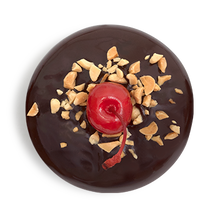 Load image into Gallery viewer, top of a banana split cupcake that has been dipped in ganache and finished with crushed peanuts and a maraschino cherry not-bg